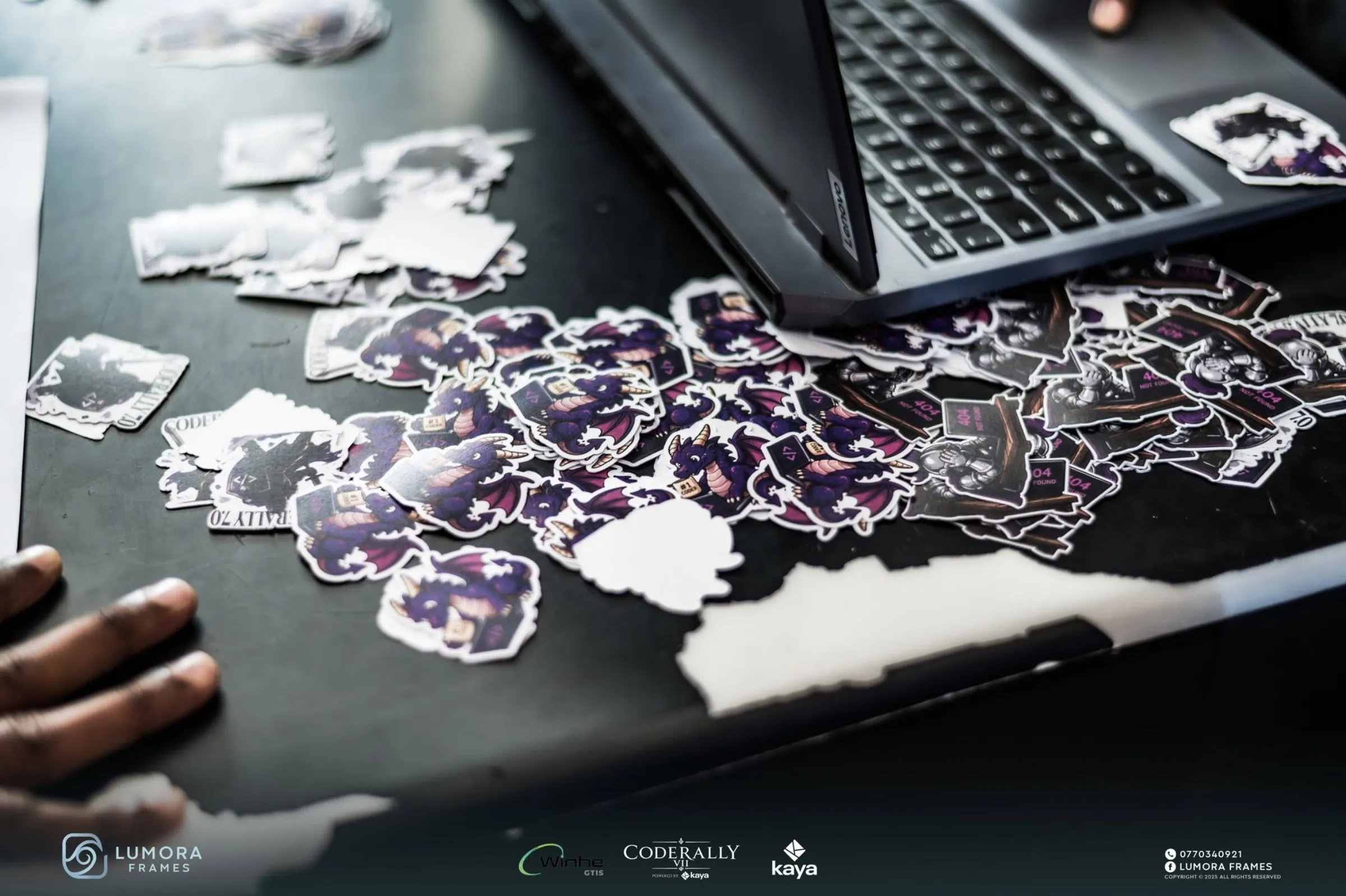 CodeRally stickers scattered beside a laptop