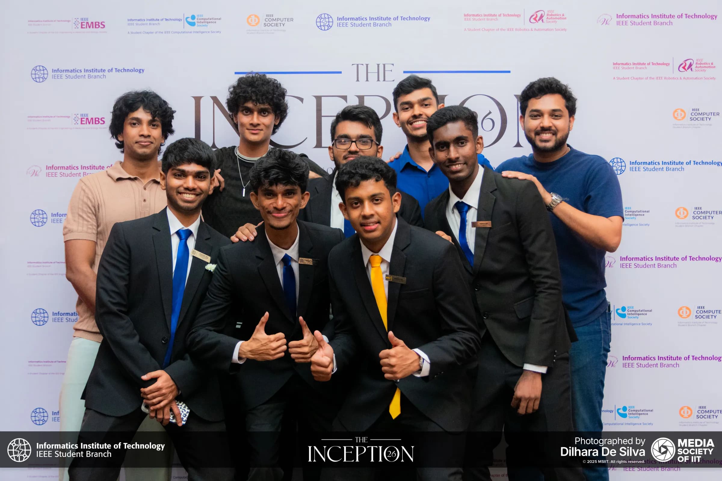Committee members and friends posing with thumbs up at The Inception 26