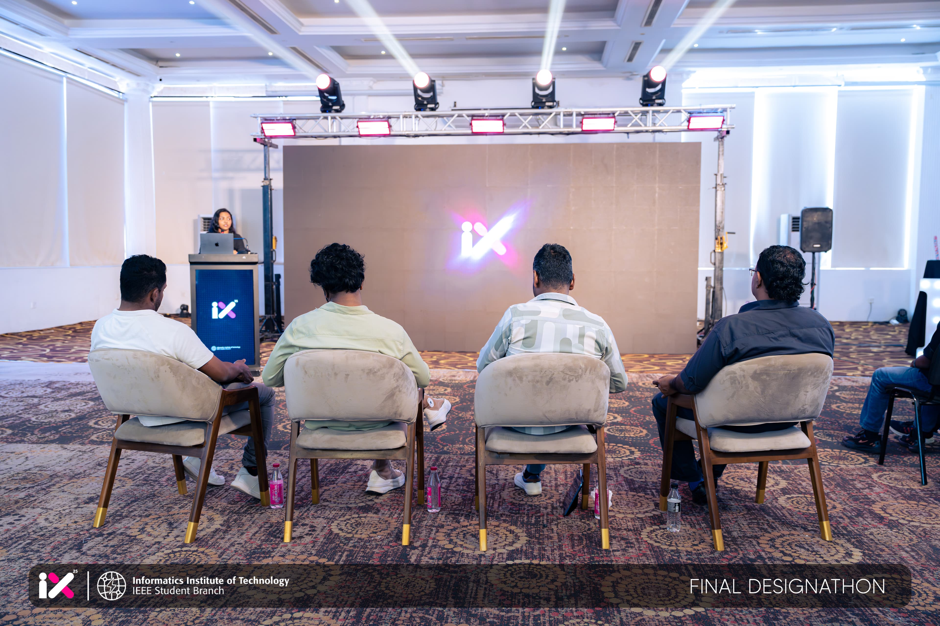 Judging panel watching the IX 25 identity mark at the Final Designathon