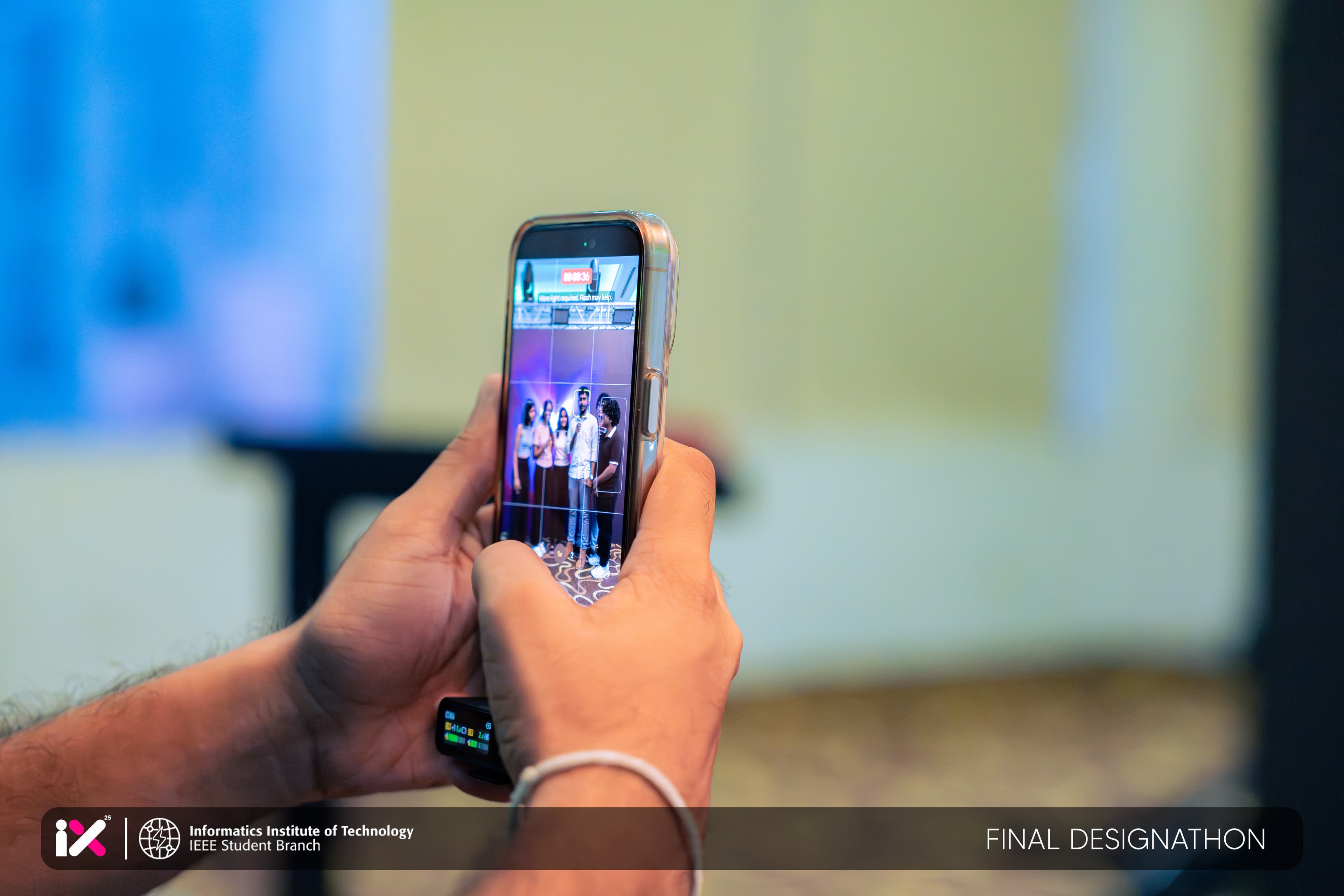 An attendee photographing the stage on their phone